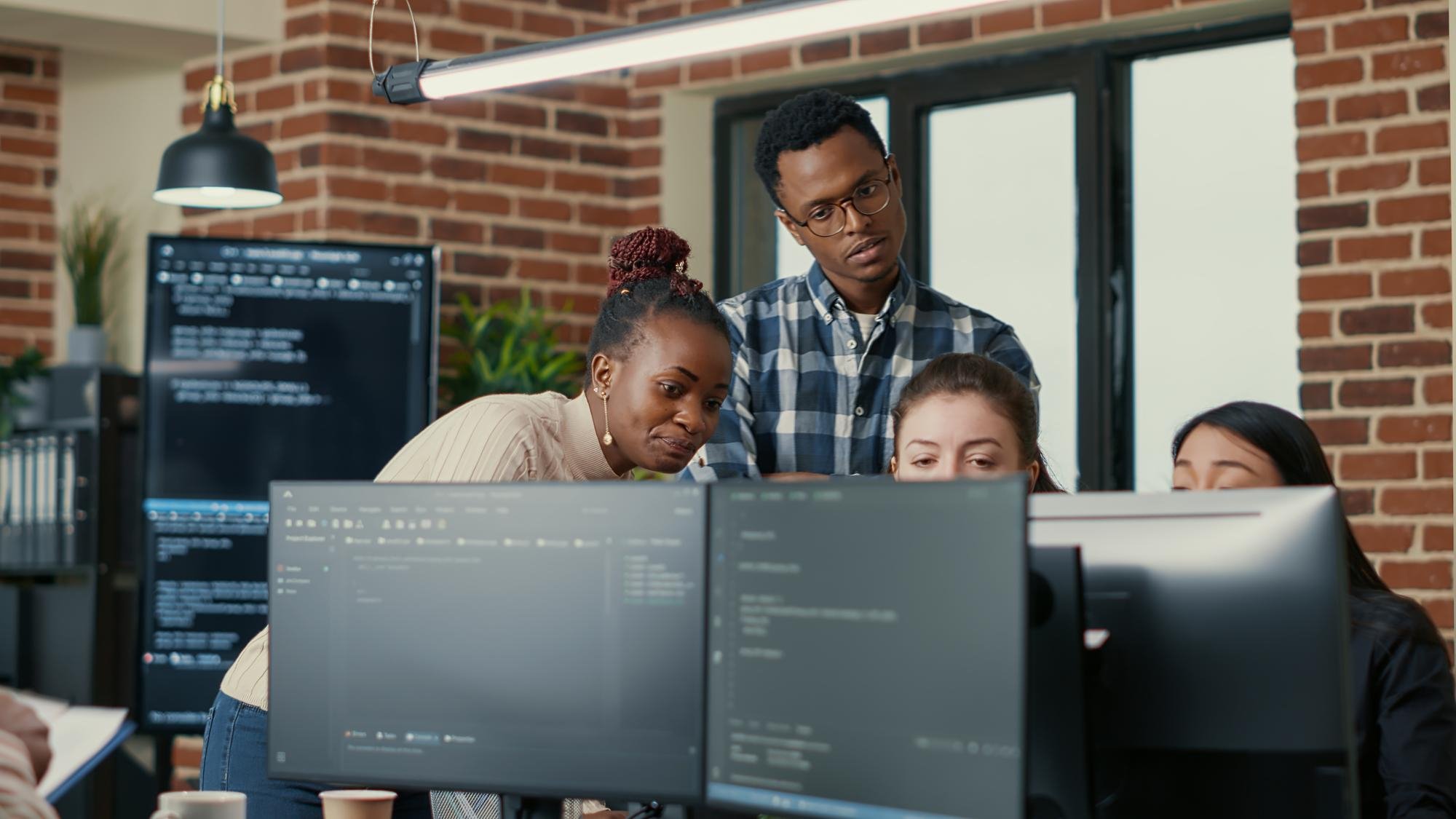 Software engineers working together at their screens