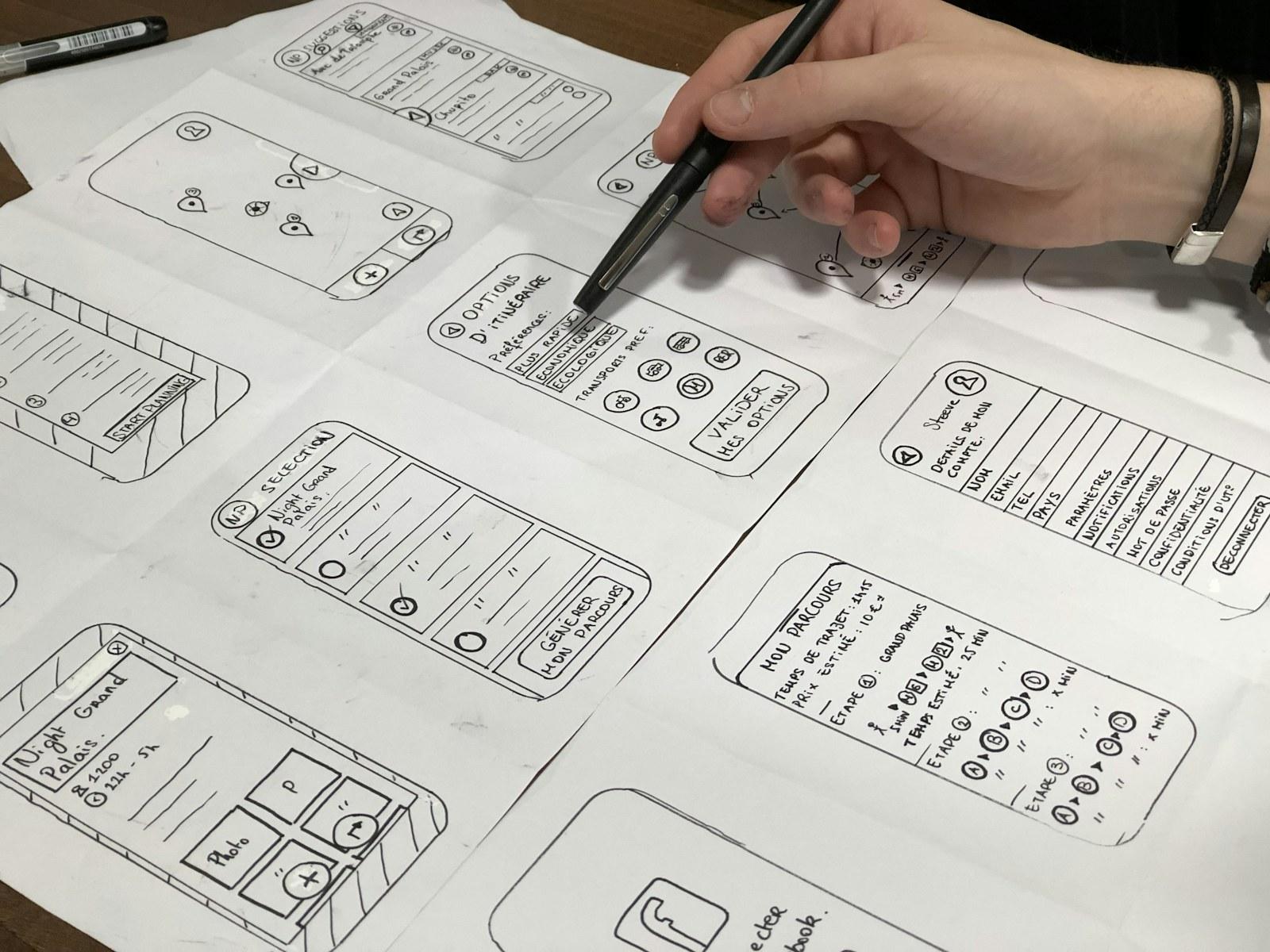 Designer sketching a mobile app experience on paper