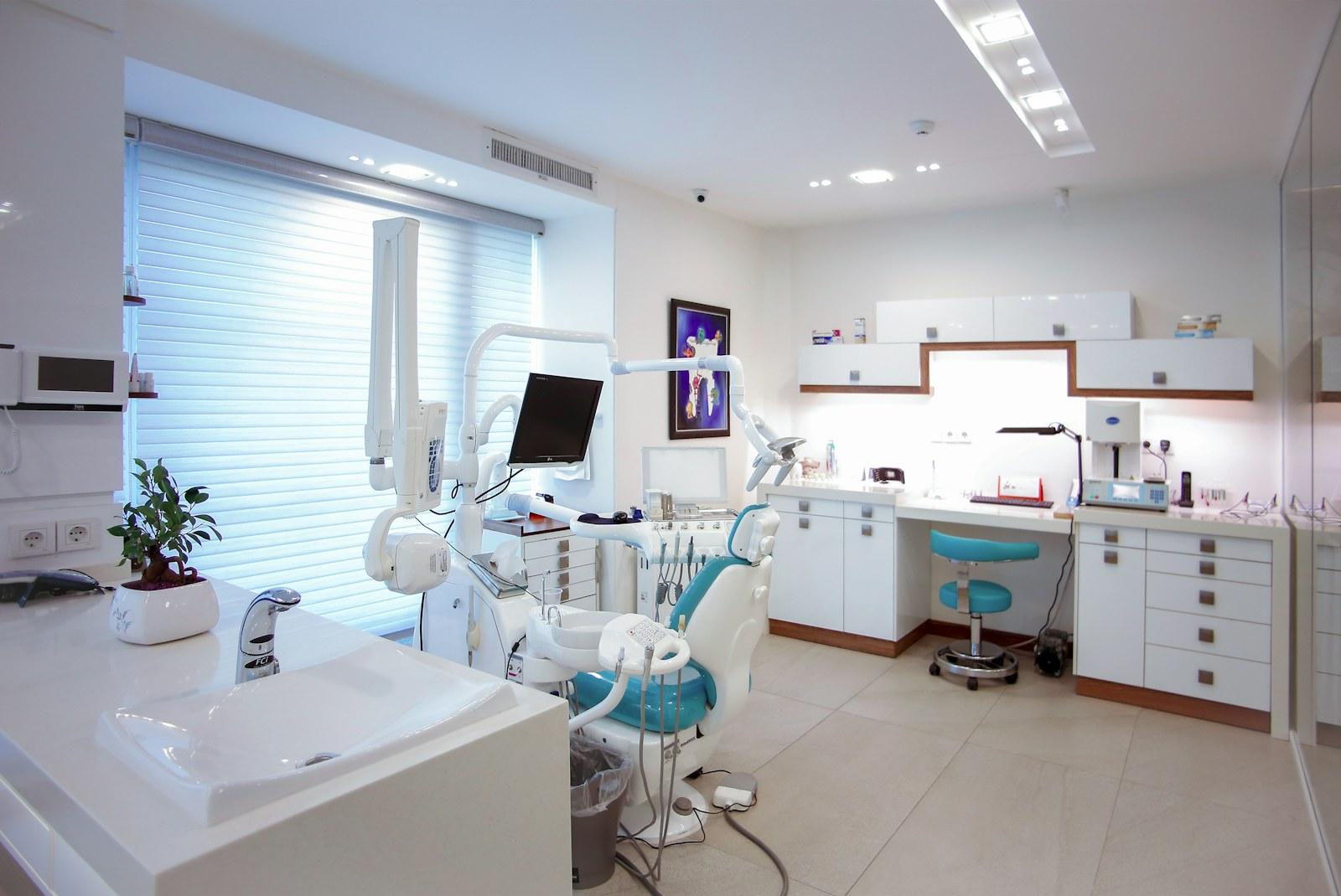 Modern dental treatment room with chair and equipment