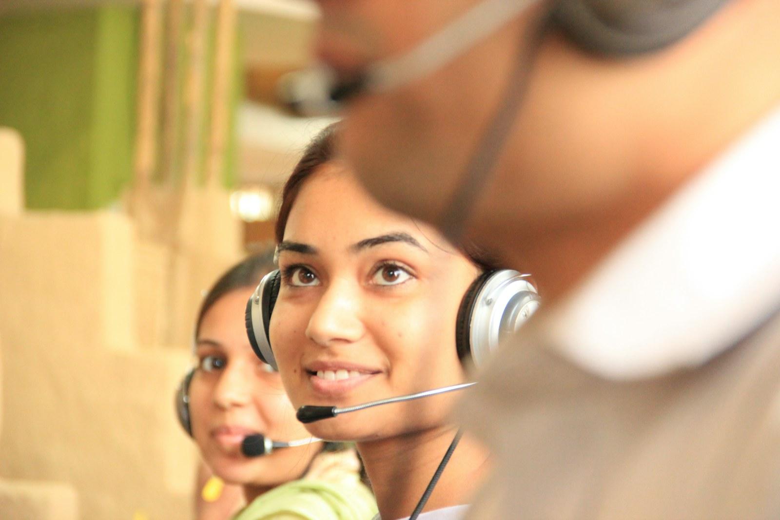 Customer support staff speaking through headsets
