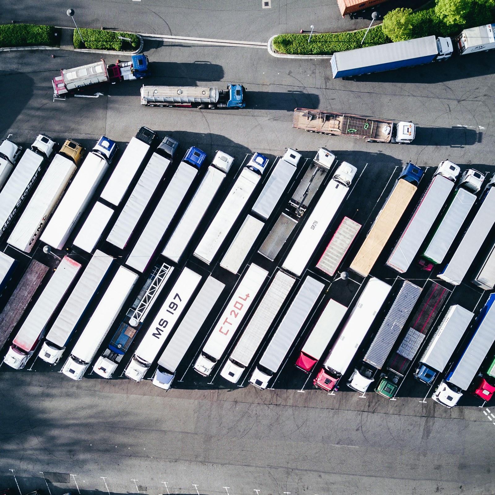 Freight trucks parked together in a vehicle lot