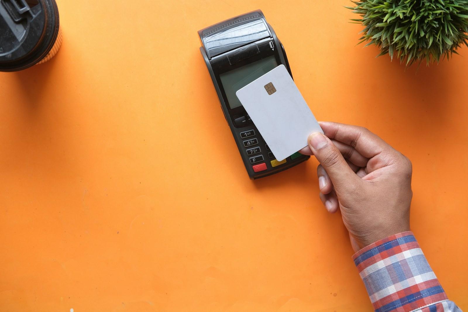 Payment card held beside a contactless terminal